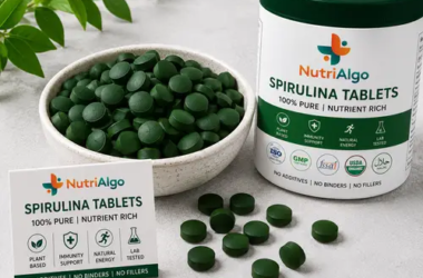 Nutriprime Spirulina Tablets in bowl and supplement container – 100% pure spirulina tablets
